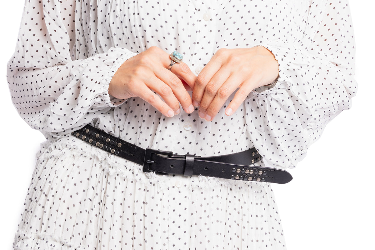 Ficus Leather Belt in black, close-up of the buckle and studded leather worn at the waist